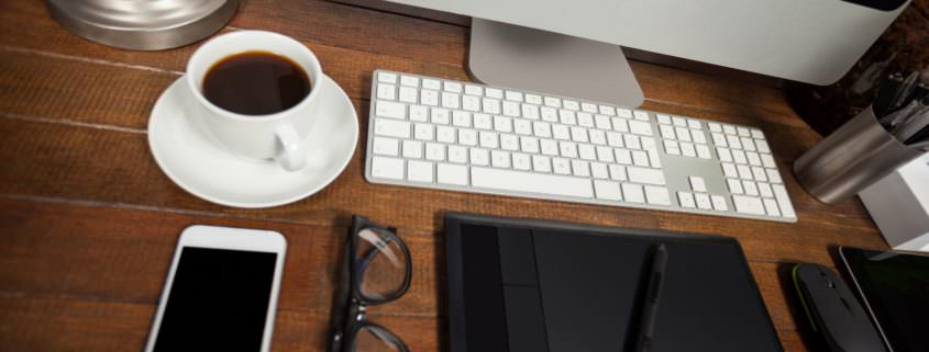 Office desk with pc, mobile phone and belongings